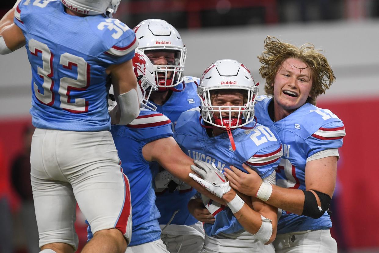 Lincoln's running back Tate Schafer (11) celebrates with victory with the team on Saturday, Nov. 11, 2023 at the Dakota Dome in Vermillion, South Dakota.