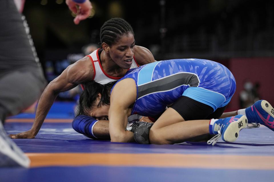 Guinea?s Fatoumata Yarie Camara, leftcompetes with Mongolia's Khongorzul Boldsaikhan during the women's 57kg Freestyle wrestling repechage match at the 2020 Summer Olympics, Thursday, Aug. 5, 2021, in Tokyo, Japan. (AP Photo/Aaron Favila)