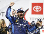 Martin Truex Jr. celebrates in Victory Lane after winning the NASCAR Cup Series auto race at Richmond Raceway in Richmond, Va., Saturday, April 13, 2019. (AP Photo/Steve Helber)