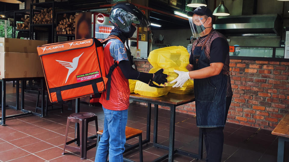 Staff (right) at Beard Brothers’ BBQ sending off an order received from its online storefront. — Picture courtesy of Beard Brothers’ BBQ