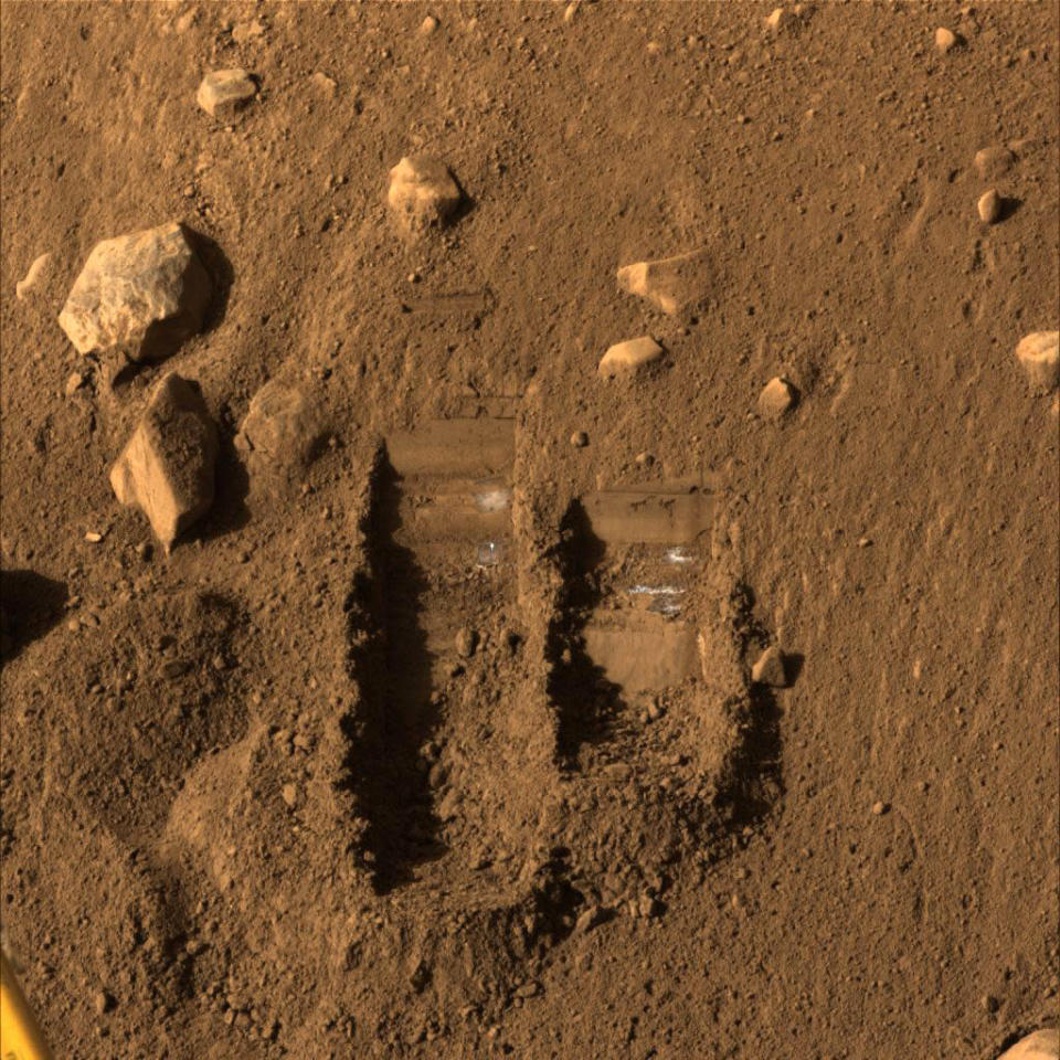 NASA's Phoenix Mars Lander's Surface Stereo Imager shows two trenches dug by Phoenix's Robotic Arm in this image taken June 8, 2008, the 14th Martian day after landing. Soil from the right trench, informally called "Baby Bear," was delivered to Phoenix's Thermal and Evolved-Gas Analyzer, or TEGA, on June 6, 2008. Picture taken June 8, 2008. REUTERS/NASA/JPL-Caltech/University of Arizona/Texas A&M University/Handout (UNITED STATES). FOR EDITORIAL USE ONLY. NOT FOR SALE FOR MARKETING OR ADVERTISING CAMPAIGNS.