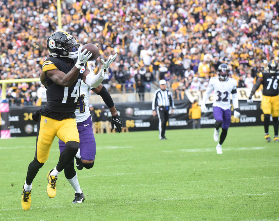 Oct 8, 2023; Pittsburgh, Pennsylvania, USA; Pittsburgh Steelers wide receiver George Pickens (14) catches a 41 yard pass for a touchdown as Baltimore Ravens cornerback Marion Humphrey (44) applies coverage during the fourth quarter at Acrisure Stadium. The catch was the game-winning score as the Steelers won 17-10. Mandatory Credit: Philip G. Pavely-USA TODAY Sports