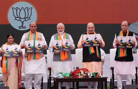 Prime Minister Narendra Modi (C), chief of Bharatiya Janata Party (BJP) Amit Shah (2-R), Home Minister Rajnath Singh (2-L) Foreign Minister Sushma Swaraj (L) and Finance Minister Arun Jaitley display copies of their party's election manifesto for the April/May general election, in New Delhi, April 8, 2019. REUTERS/Adnan Abidi/Files