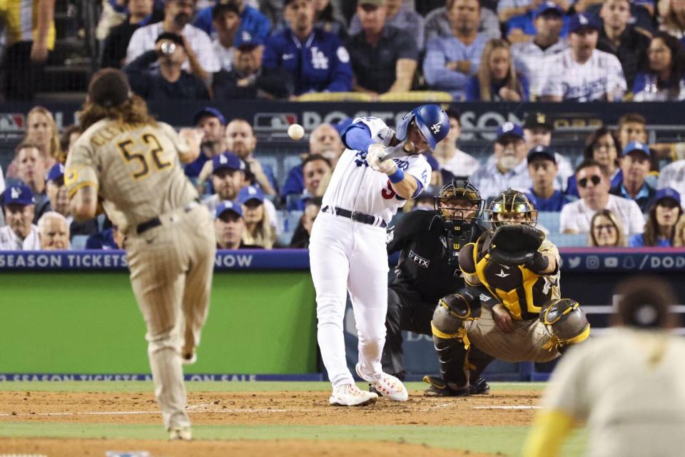 Gavin Lux hits a double off the Padres' Mike Clevinger.