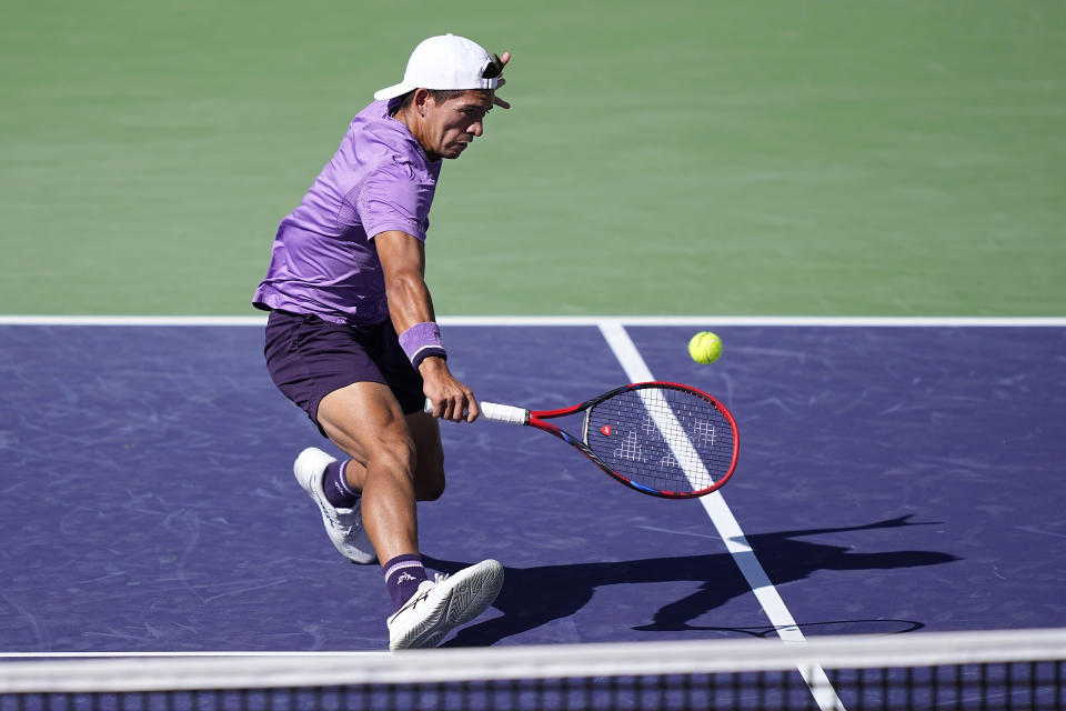 Sebastian Baez, of Argentina, returns a shot against Taylor Fritz, of the United States, at the BNP Paribas Open tennis tournament, Monday, March 11, 2024, in Indian Wells, Calif. (AP Photo/Mark J. Terrill)