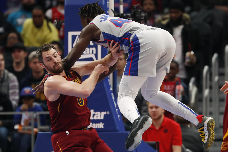 Detroit Pistons forward Sekou Doumbouya (45) falls onto Cleveland Cavaliers forward Kevin Love during the first half of an NBA basketball game, Monday, Jan. 27, 2020, in Detroit. (AP Photo/Carlos Osorio)