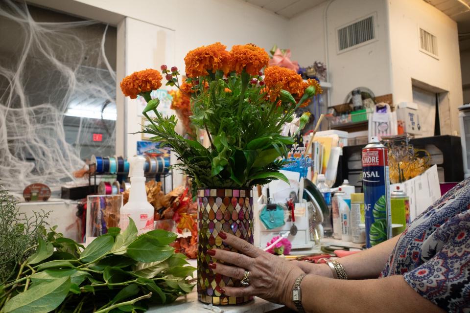 A finished cempasúchil, or marigold, arrangement made by hand by María Elena Palacios is sold at Yosi's Flower Shop in Tucson.