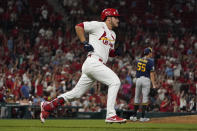 St. Louis Cardinals' Nolan Arenado, left, rounds the bases after hitting a solo home run off Milwaukee Brewers pitcher Hoby Milner (55) during the seventh inning of a baseball game Tuesday, Sept. 28, 2021, in St. Louis. (AP Photo/Jeff Roberson)