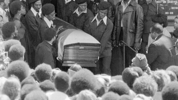 George Jackson’s casket, draped in a flag with a Black Panther emblem, is carried from St. Augustine’s Episcopal Chruch on Aug. 28, 1971 in Oakland. First celebrated in 1979, Black August was originally created to commemorate Jackson’s fight for Black liberation. (Photo: AP, File)