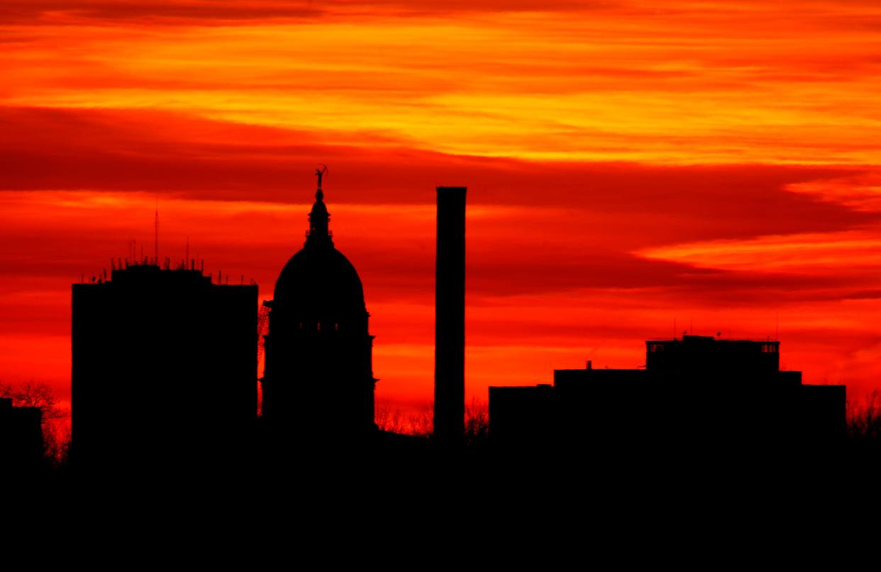 The sun sets behind the Kansas Statehouse in downtown Topeka, Kan., Monday, Dec. 21, 2009.