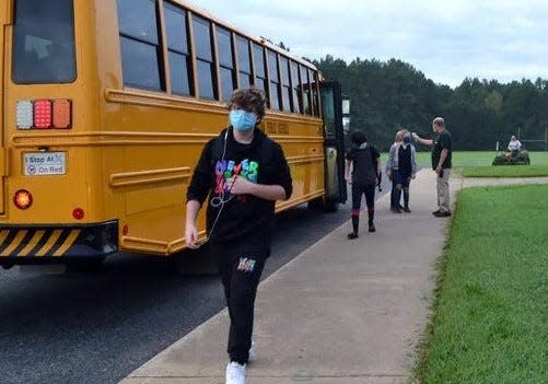 Cleveland County students exit a school bus on their way to school.