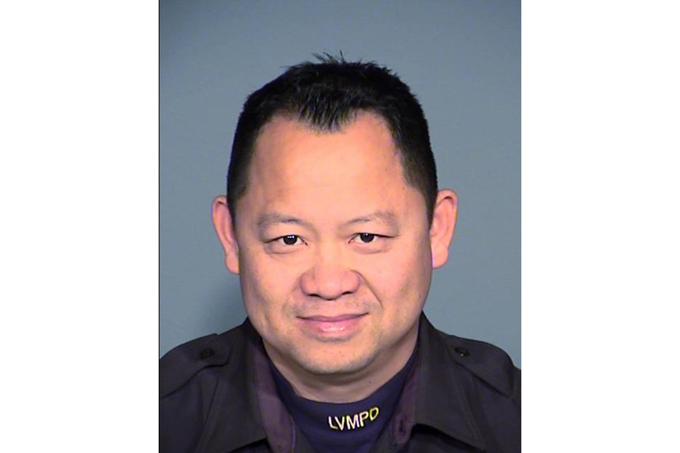 This undated photo provided by Las Vegas police shows Officer Truong Thai, 49. Clark County Sheriff Joe Lombardo told reporters that Thai was fatally wounded early Thursday, Oct. 13, 2022, in an exchange of gunfire with a man in a vehicle while answering a domestic violence call east of the Las Vegas Strip. Police say Tyson Hampton, 24, of Las Vegas was arrested as the suspect in the shooting. (Las Vegas Metropolitan Police Department via AP)