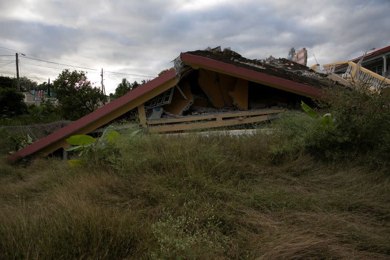 A house that collapsed on its foundation is seen after an earthquake in Yauco