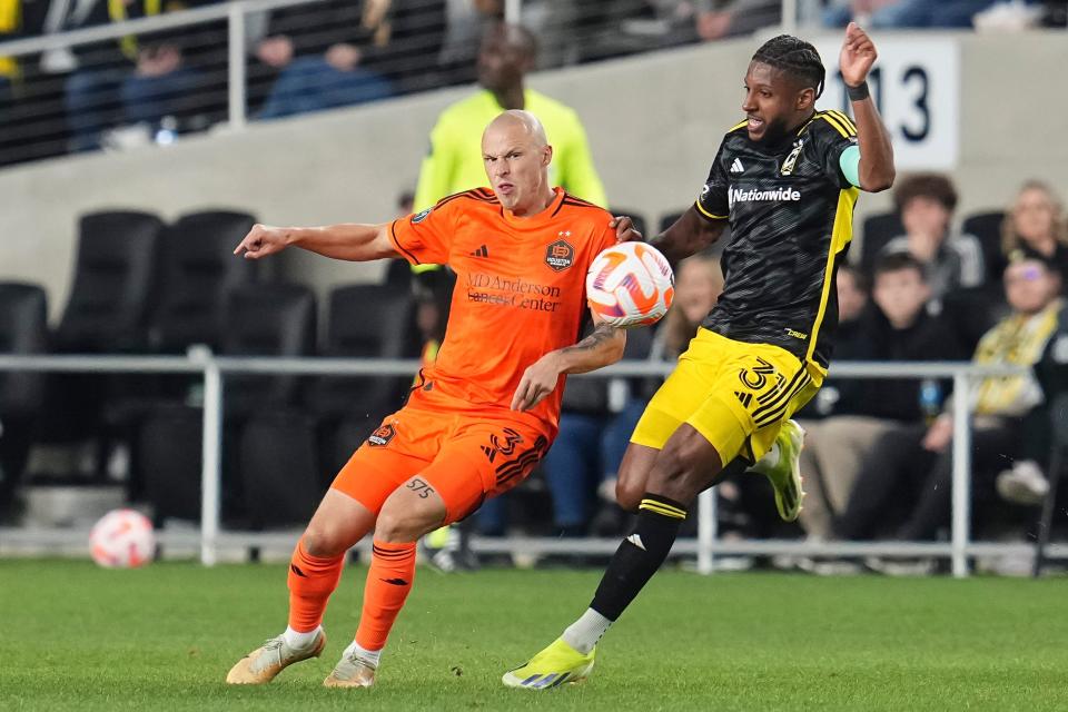 Mar 12, 2024; Columbus, OH, USA; Houston Dynamo defender Brad Smith (3) kicks the ball past Columbus Crew defender Steven Moreira (31) during the second half of the Concacaf Champions Cup soccer game at Lower.com Field. Mandatory Credit: Adam Cairns-USA TODAY Sports