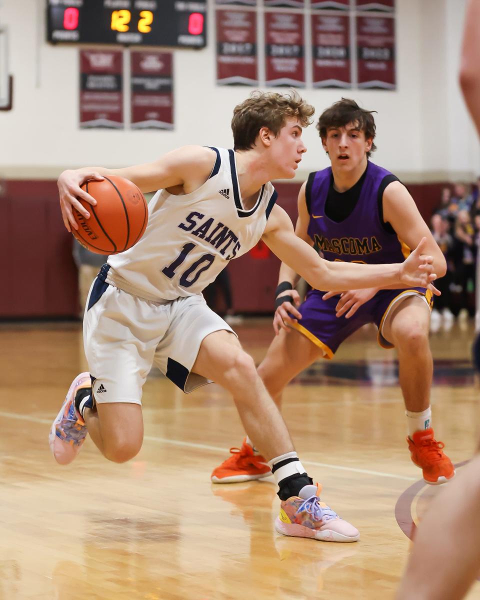 St. Thomas Aquinas freshman AJ Reinertson is defended by Mascoma's Zach Thompson during Wednesday's Division III boys basketball semifinal at Goffstown High School.