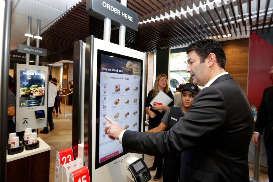 McDonald's CEO Steve Easterbrook demonstrates an order kiosk, with cashier Esmirna DeLeon, during a presentation at a McDonald's restaurant in Manhattan. McDonald’s has started testing mobile order-and-pay after acknowledging the ordering process in its restaurants can be “stressful.”