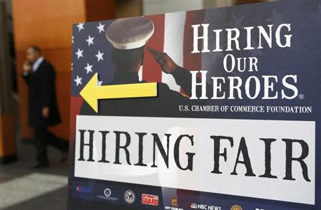 A sign points the way for military personnel, veterans and military spouses attending the Hiring Our Heroes job fair in Washington January 10, 2014. REUTERS/Kevin Lamarque