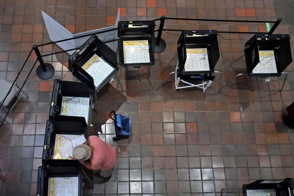 A voter fills out his ballot, Monday, Aug. 8, 2022, at the Stephen P. Clark Government Center in Miami. Early voting in the Aug 23 primary election began Monday in Palm Beach and Miami-Dade Counties.