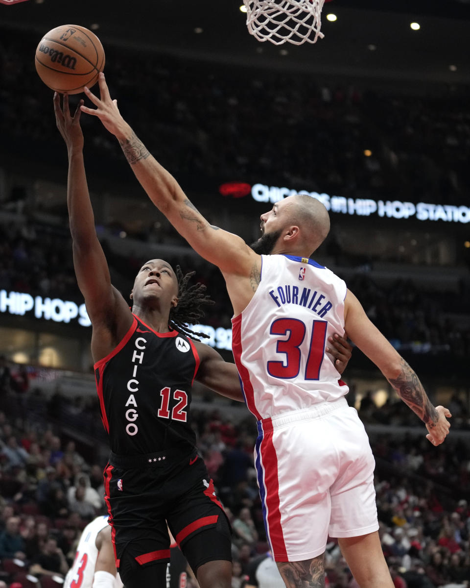 Detroit Pistons' Evan Fournier (31) blocks the shot of Chicago Bulls' Ayo Dosunmu during the first half of an NBA basketball game Tuesday, Feb. 27, 2024, in Chicago. (AP Photo/Charles Rex Arbogast)