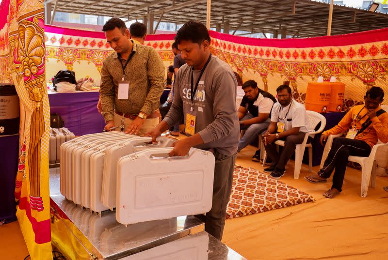 Election staff keeps Electronic Voting Machines (EVM) on metal box before dispatching them from a warehouse ahead of India's general election in Ahmedabad