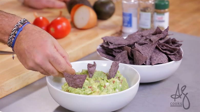 Andrew Zimmern scooping homemade guacamole