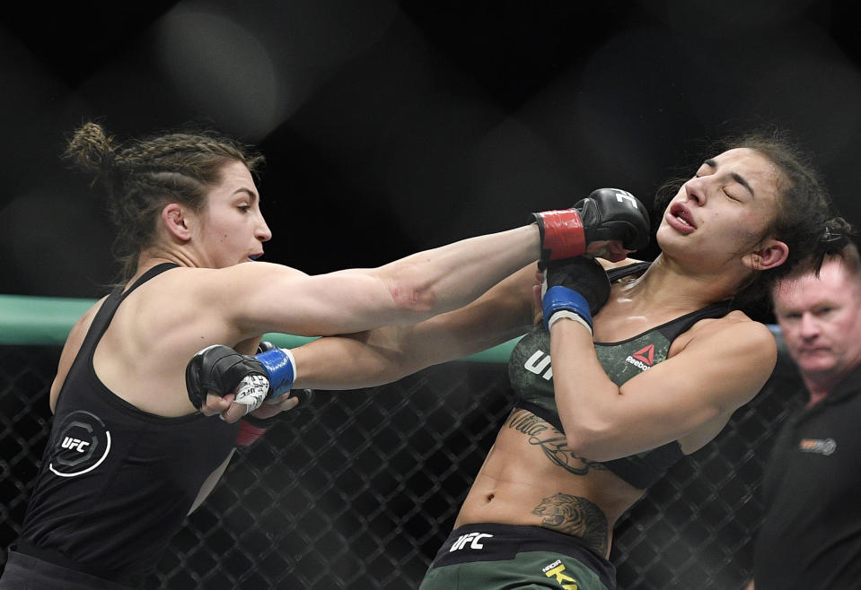 Montana De La Rosa, left, of the U.S., and Australia's Nadia Kassem fight during their Women's Flyweight bout at the UFC 234 event in Melbourne, Australia, Sunday, Feb. 10, 2019. (AP Photo/Andy Brownbill)