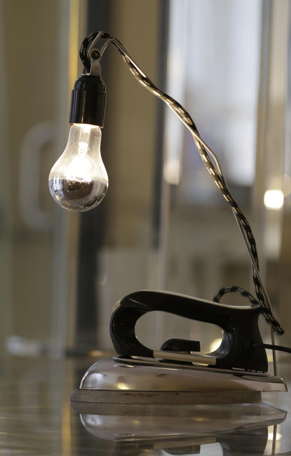 A table lamp made from an old iron is displayed at the 'Unico' showroom during the Milan's Design Fair, in Milan, Italy, Thursday, April 11, 2013. The Milan furniture and design week fair, showcasing the latest in furniture and design from countries around the world, will continue until Sunday. (AP Photo/Luca Bruno)