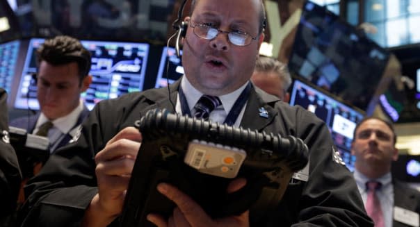 Wall Street (Trader Jeffrey Vazquez works on the floor of the New York Stock Exchange Friday, Oct. 11, 2013. Stocks were inching