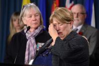 Nicole Paul, right, who is the mother of Canadian Greenpeace activists Alexandre Paul, wipes away tears as she is comforted by Patti Stirling, sister of Canadian Greenpeace activist Paul Ruzycki, as they take part in a press conference on Parliament Hill in Ottawa on Tuesday, October 30, 2013 regarding the detention of their family members in Russia. THE CANADIAN PRESS/Sean Kilpatrick