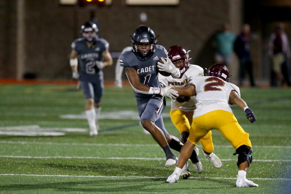 Benedictine's Za'Quan Bryan slips between two New Hampstead defenders during a game on Oct. 22, 2021.