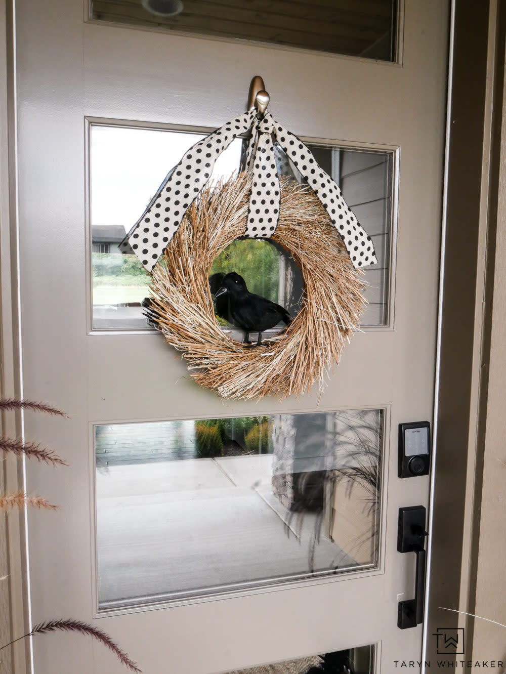 natural wreath with faux crow in middle (Taryn Whiteaker)