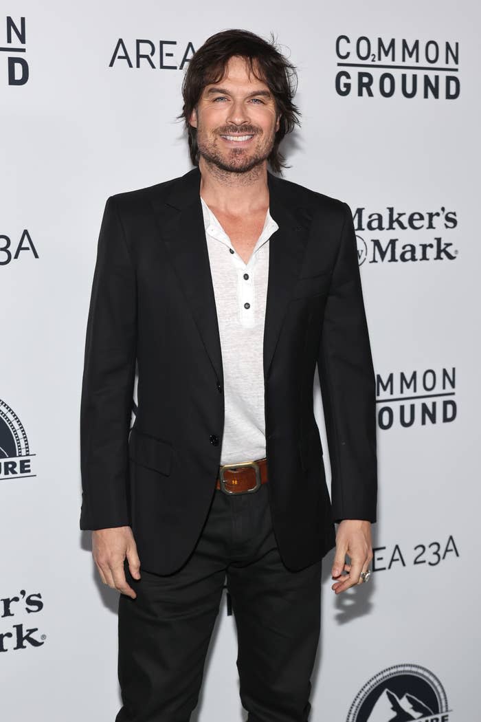 Ian smiling for photographers on the red carpet of an event