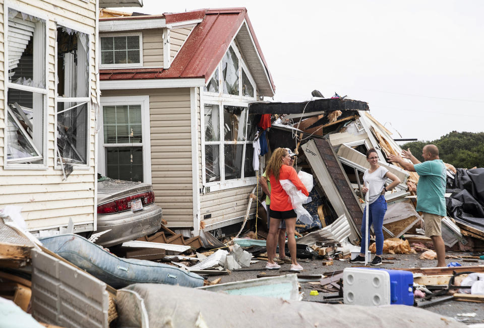 Residents of the Boardwalk RV Park in Emerald Isle, N.C., discuss the path of Hurricane Dorian's waterspout after it ripped through their community on Thursday, Sept. 5, 2019. (Julia Wall/Raleigh News & Observer/Tribune News Service via Getty Images)