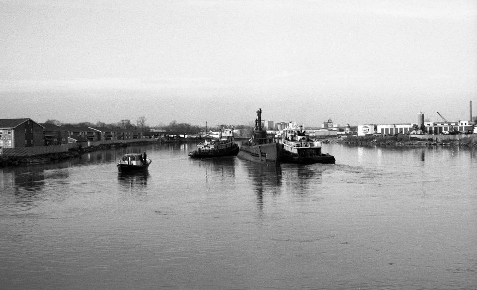 World War II submarine U.S.S. Ling, assisted by a tug boat,  makes its way toward its new memorial berth on the Hackensack River in Hackensack, N.J., on January 13, 1973.