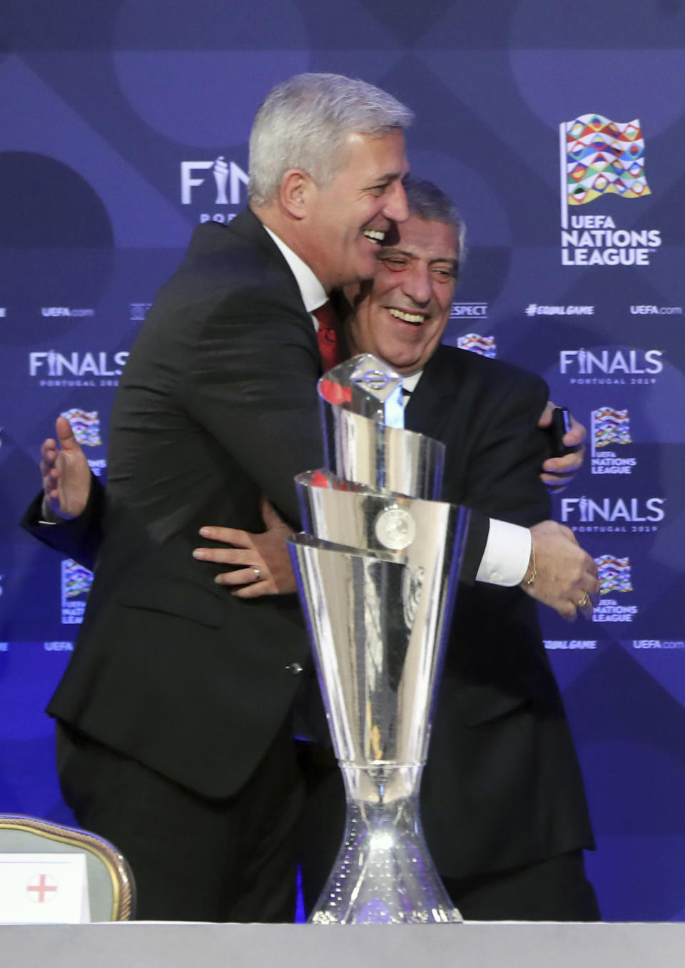 Portugal soccer team manager Fernando Santos, right, and Switzerland manager Vladimir Petkovic embrace during a press conference after the UEFA Nations League Finals draw at the Shelbourne Hotel, Dublin, Monday Dec. 3, 2018. (Niall Carson/PA via AP)