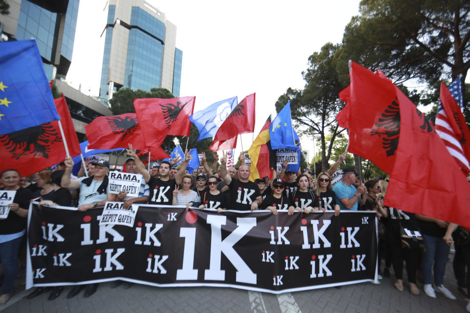 Demonstrators show a banner reading: GO, during an anti-government protest in Tirana, Albania, Saturday, June 8, 2019. Thousands of Albanian opposition supporters are gathering in an anti-government protest while the United States and the European Union caution their leaders to disavow violence and sit in a dialogue to overcome the political crisis. (AP Photo/Hektor Pustina)