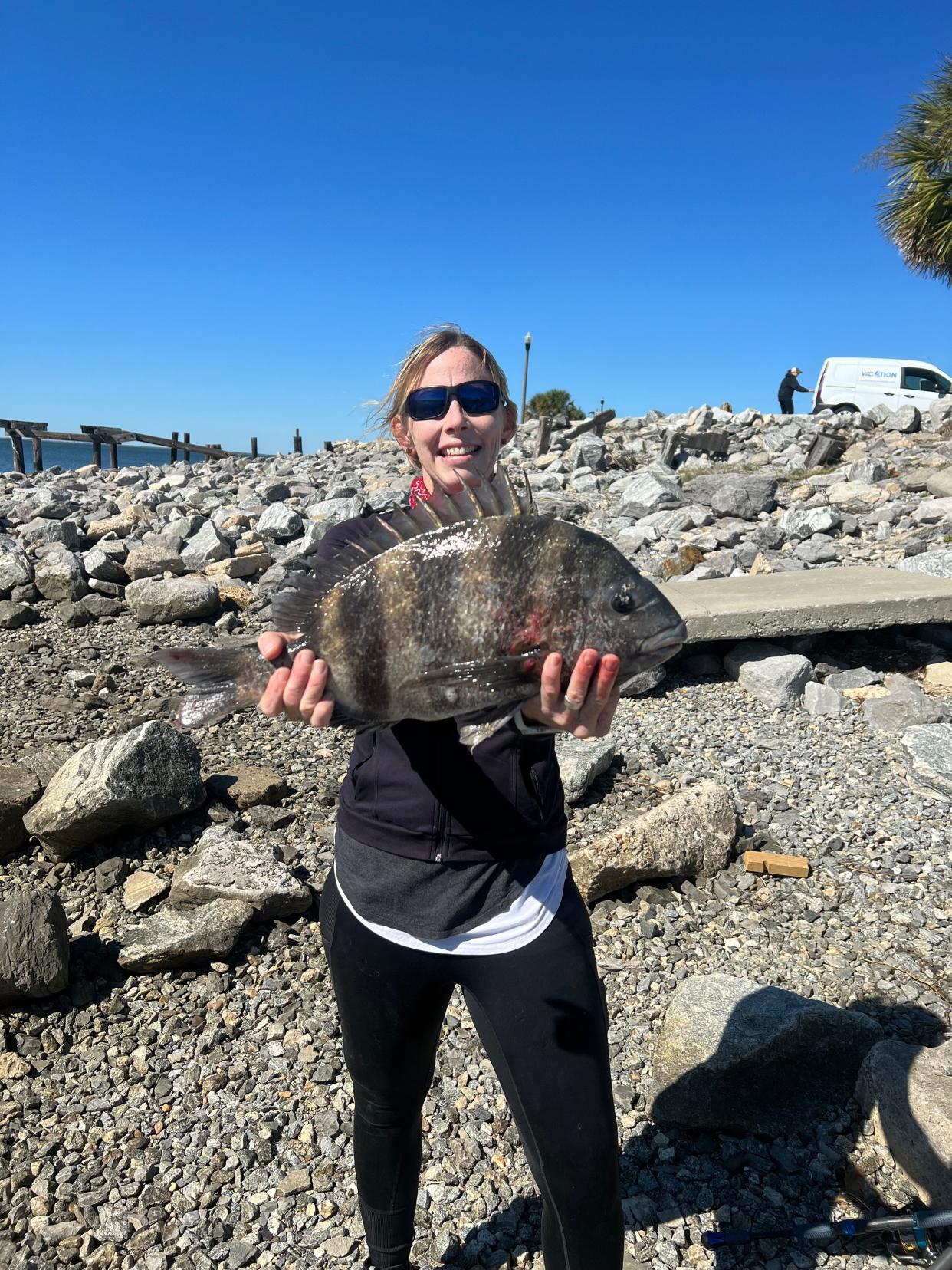 Sydni Booth, of Port St. Joe, holds up a big ole’ sheepshead caught off a Mexico Beach sea wall.