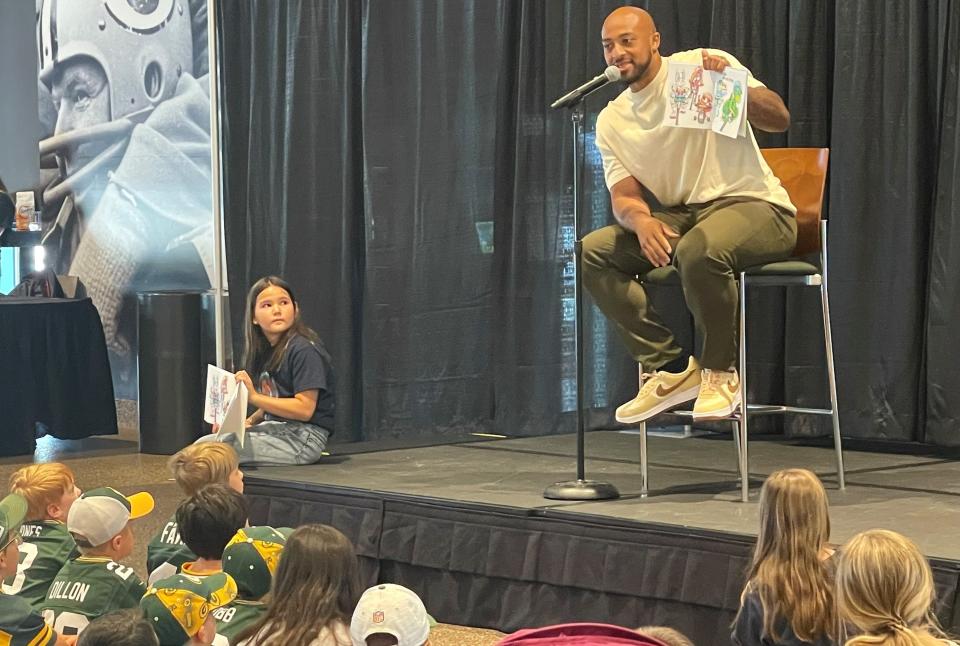 Before fans lined up for a signing and photos with Green Bay Back running back AJ Dillon, he did his first reading of "Quadzilla Finds His Footing" at Johnsonville Tailgate Village.