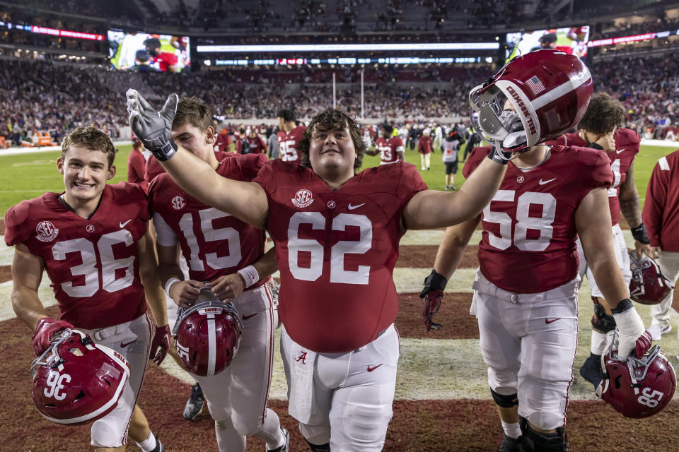 Alabama offensive lineman Jackson Roby (62) salutes the fans as he and his teammates depart the field after an NCAA college football game against Auburn, Saturday, Nov. 26, 2022, in Tuscaloosa, Ala. (AP Photo/Vasha Hunt)