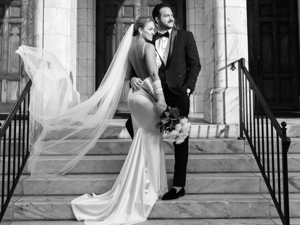 A bride and groom. The bride is facing her back to the camera.