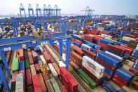 FILE - In this Tuesday, May 14, 2019, file photo, containers are piled up at a port in Qingdao in east China's Shandong province. China’s exports rose 0.5% in 2019 despite a tariff war with Washington after growth rebounded in December on stronger demand from other markets. Exports to the United States fell 12.5% compared with 2018 after a 14.5% contraction in December, customs data showed Tuesday, Jan. 14, 2020. (Chinatopix via AP, File)