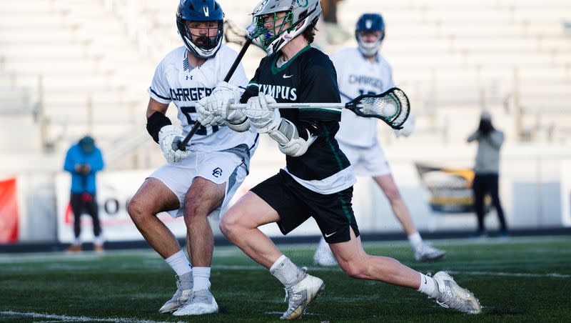 Olympus’ Gage Phippen (11) shoots the ball during a high school boys lacrosse game at Corner Canyon High School in Draper on April 14, 2023.