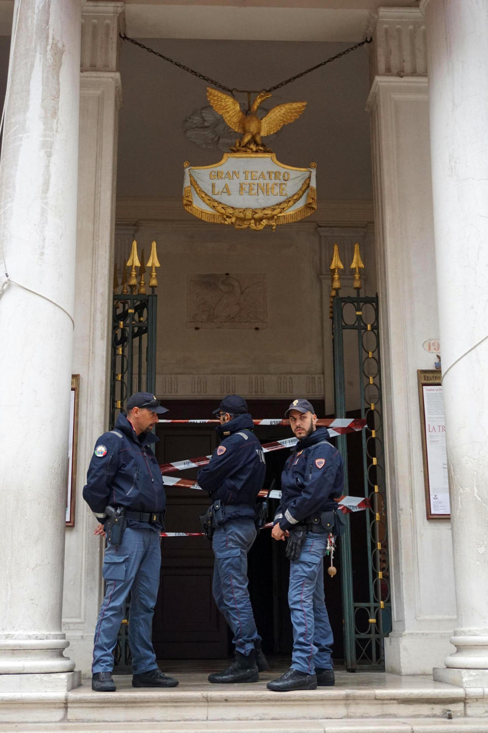 Police officer cordon off the entrance of La Fenice opera house after a fire apparently broke out in a technical room, in Venice, Italy, Monday, Oct. 1, 2018. According to agencies a fire has been brought swiftly under control in Venice's La Fenice opera house, which was rebuilt after being destroyed by flames in 1996. (Andrea Merola/ANSA via AP)