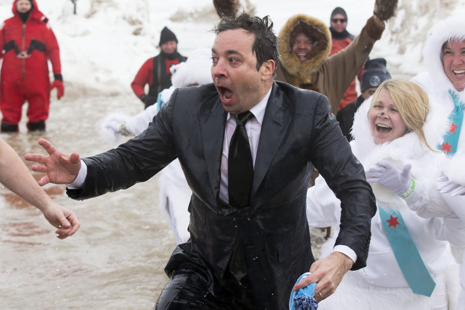 "The Tonight Show" host Jimmy Fallon, center, exits the water during the Chicago Polar Plunge, Sunday, March 2, 2014, in Chicago. Fallon joined Chicago Mayor Rahm Emanuel in the event. (AP Photo/Andrew A. Nelles)