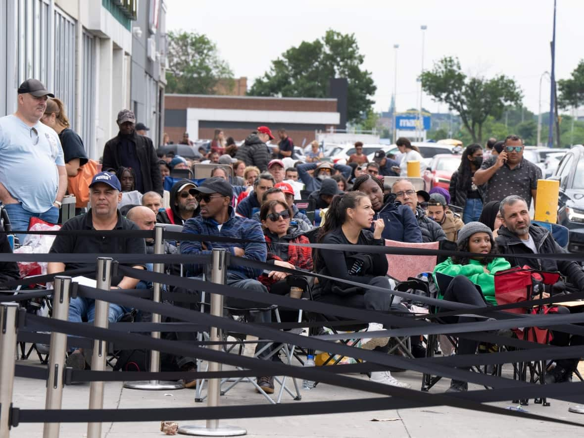 People line up at a passport office in Montreal, Wednesday, June 22, 2022. (Ryan Remiorz/Canadian Press - image credit)