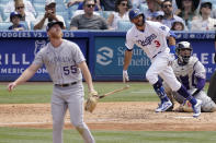 Los Angeles Dodgers' Chris Taylor, center, runs to first as he hits a solo home run while Colorado Rockies starting pitcher Jon Gray, left, watches along with catcher Elias Diaz during the fifth inning of a baseball game Sunday, July 25, 2021, in Los Angeles. (AP Photo/Mark J. Terrill)