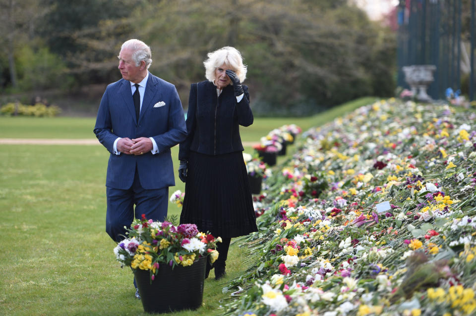 Britain's Prince Charles, Prince of Wales (L) and Britain's Camilla, Duchess of Cornwall visit the gardens of Marlborough House in London on April 15, 2021, to view the flowers and messages of condolence left by members of the public outside Buckingham Palace, following the April 9 death of Britain's Prince Philip, Duke of Edinburgh. - The Duke of Edinburgh, who died last Friday, will be buried on April 17 at Windsor Castle, west of London, with just 30 mourners, most of them close family. (Photo by Jeremy SELWYN / POOL / AFP) (Photo by JEREMY SELWYN/POOL/AFP via Getty Images)
