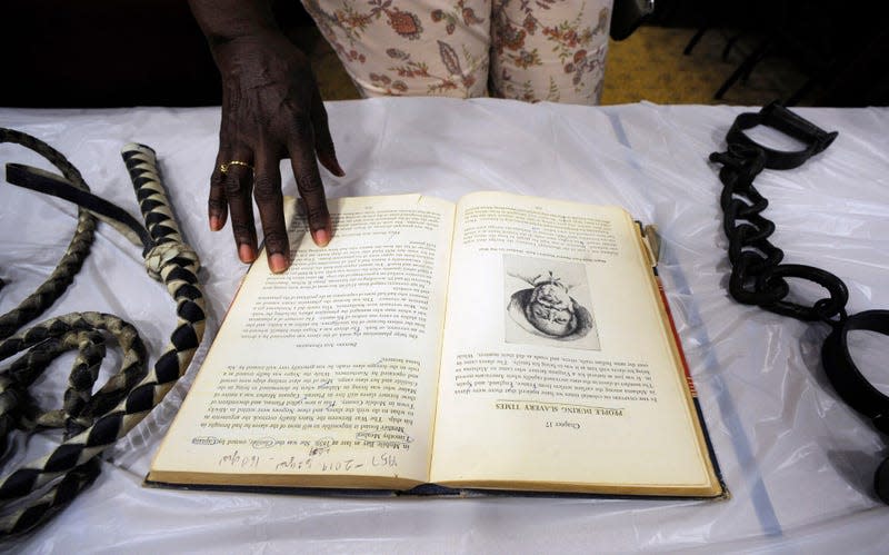 Barbara Martin looks at a display about slavery in Mobile, Ala., on Monday, Aug. 26, 2019. 