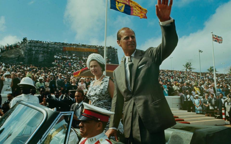 Queen Elizabeth II with her husband Prince Philip, Duke of Edinburgh in a car during a motorcade tour, Nassau, Bahamas, 1966  - Lynn Pelham 