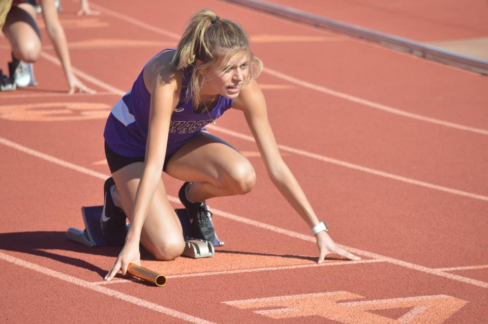 Shasta High School senior sprinter Abby Moore takes her mark before a relay race during the Eagle Classic Relays at West Valley High School on Friday, March 25, 2022.